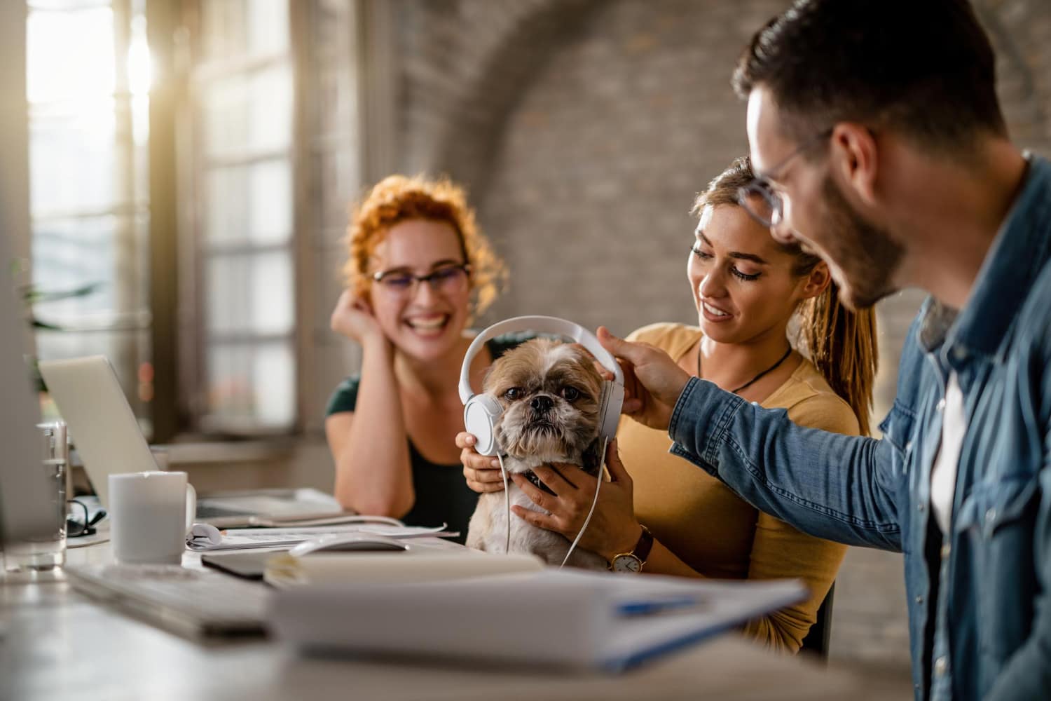Smiling veterinarian showing a pet insurance comparison chart with deductible and premium options for 2025.